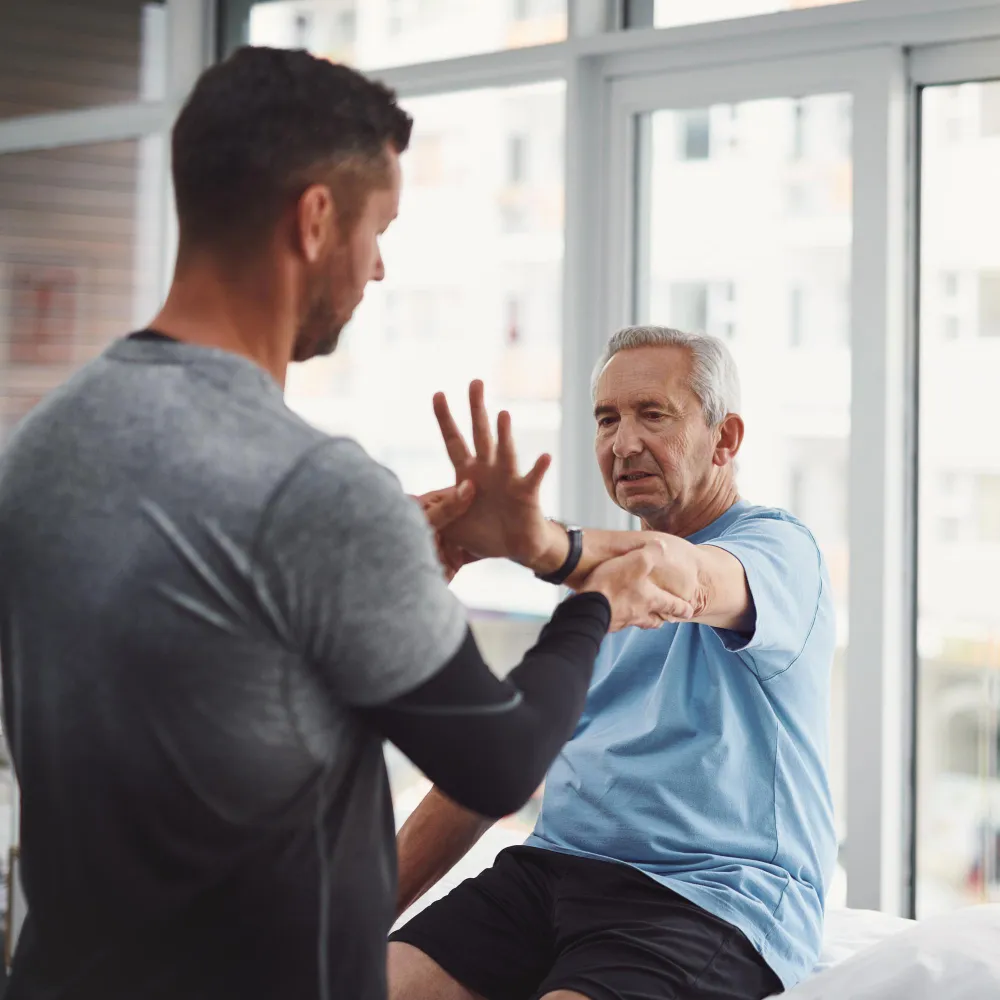 Healthcare professional assisting a patient with physical rehabilitation as part of Injury Recovery Services in Jacksonville.