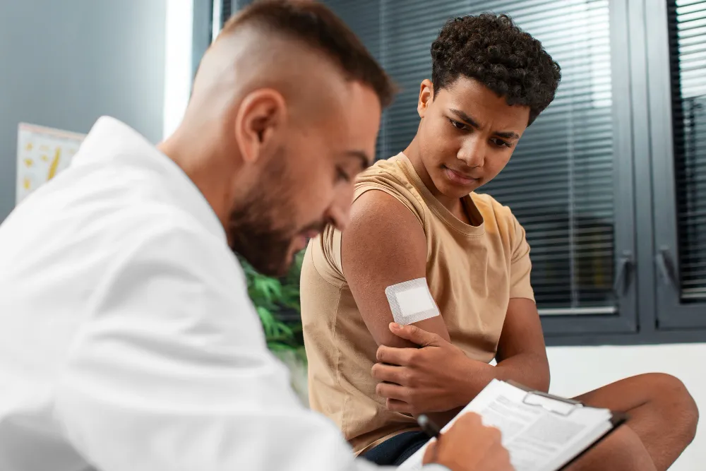 Healthcare provider treating a young patient’s arm wound, representing Wound Care in Jacksonville FL.