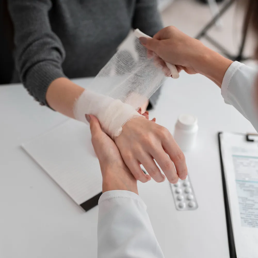 Healthcare professional dressing a patient’s hand wound as part of Advanced Wound Care Pharmacy treatment.
