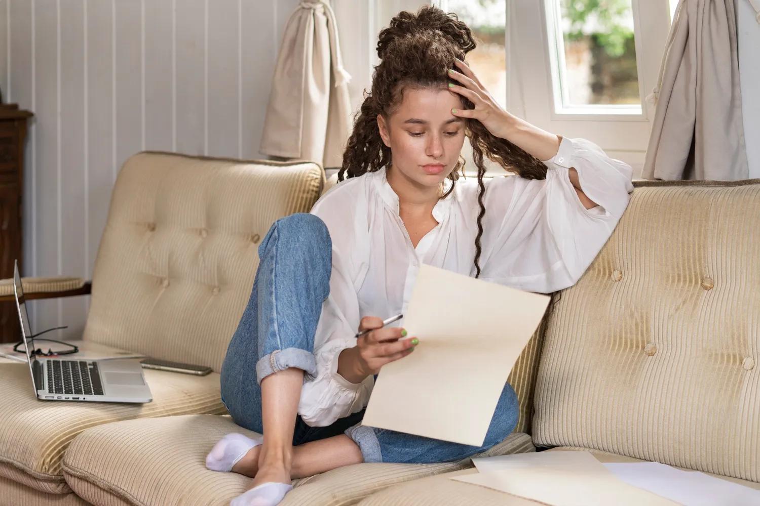 Woman experiencing stress and emotional distress while working from home, illustrating anxiety or depression symptoms.