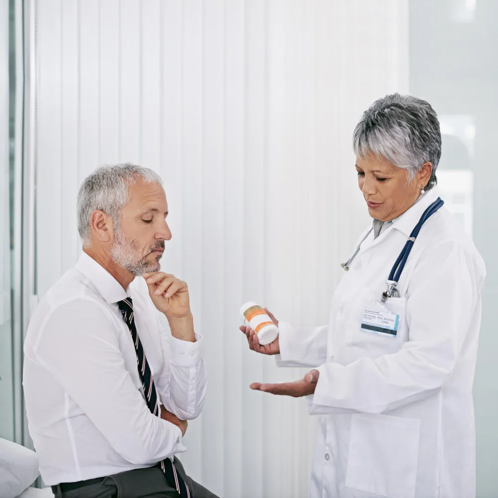 Doctor explaining personalized low dose naltrexone compounding pharmacy treatment to patient during medical consultation