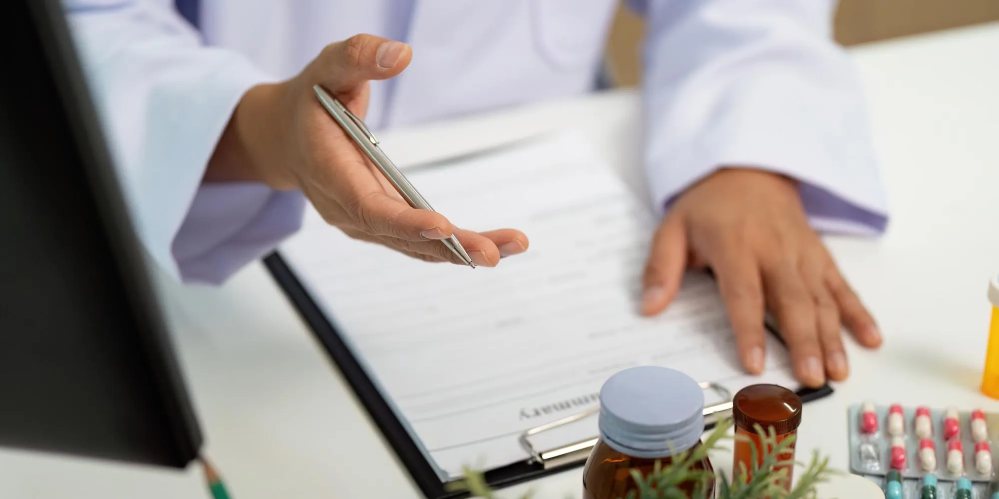 Close-up of a pharmacist reviewing a prescription with compounded medications, representing Compounding Pharmacy Jacksonville services that provide personalized medication solutions for individual patient needs.