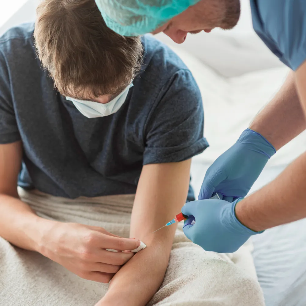 Medical professional administering wound care treatment to a patient, combining specialized medications, advanced wound management, and personalized care to support healing of diabetic ulcers and chronic wounds.