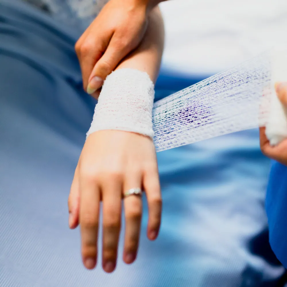 Patient receiving a wound dressing, representing custom wound care medication and compounding pharmacy solutions.