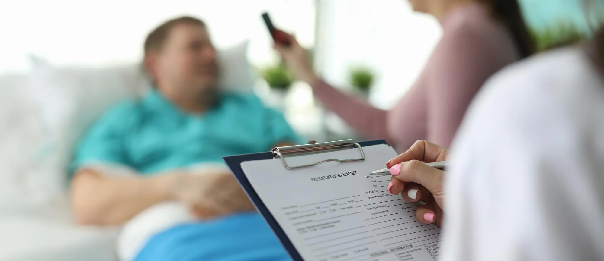 Healthcare professional reviewing a patient’s medical history during an HRT consultation.