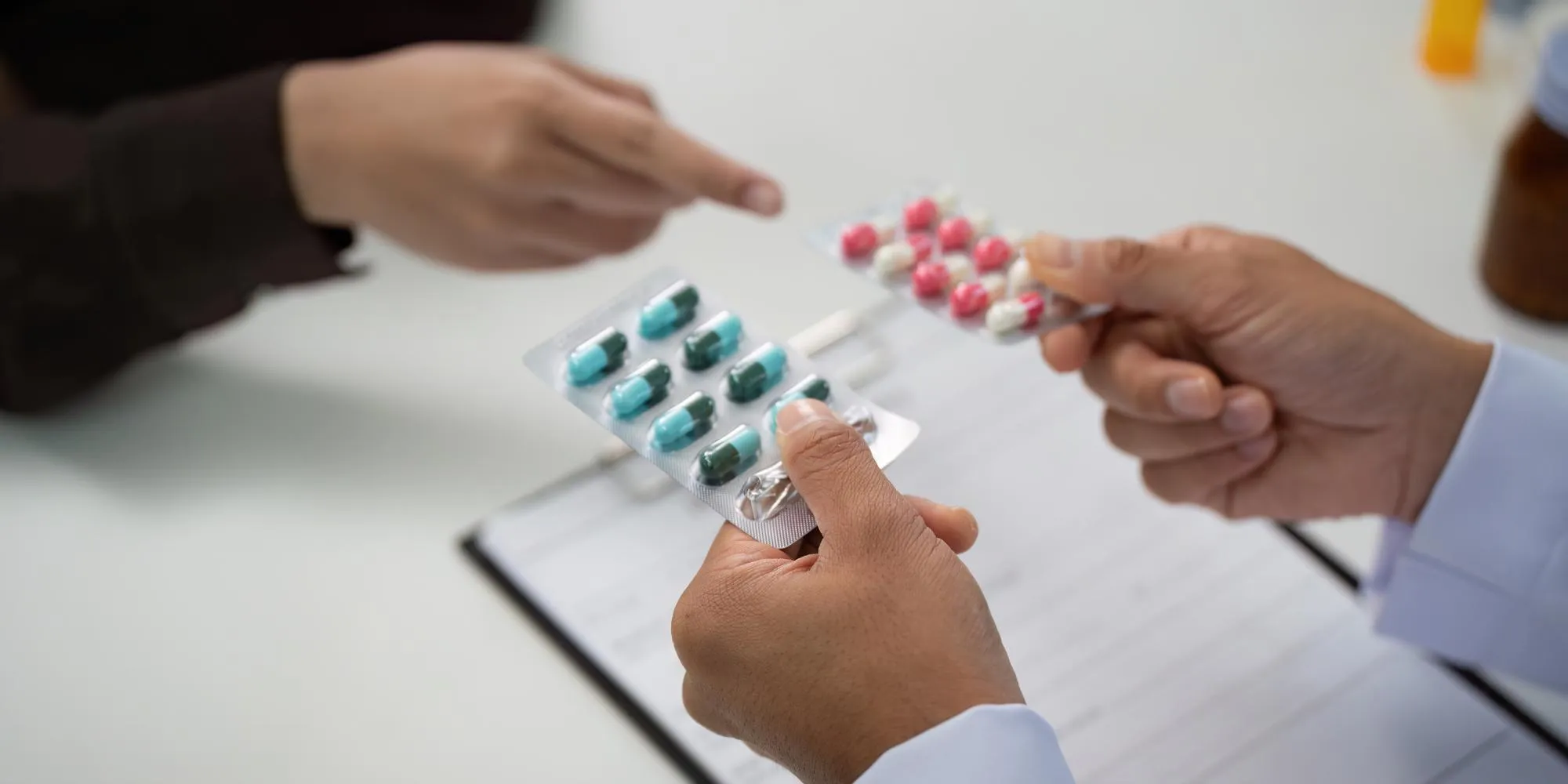 Healthcare professional discussing medication options and blister-packed prescriptions to support personalized care at a Citizen compounding pharmacy in Jacksonville.